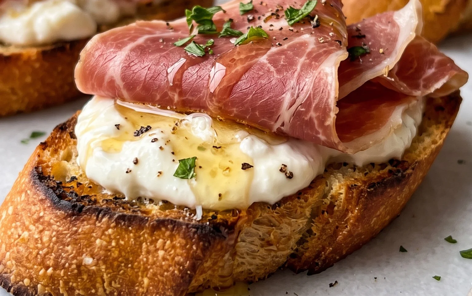Beef Prosciutto Crostini with Burrata and Lemon Honey Drizzle