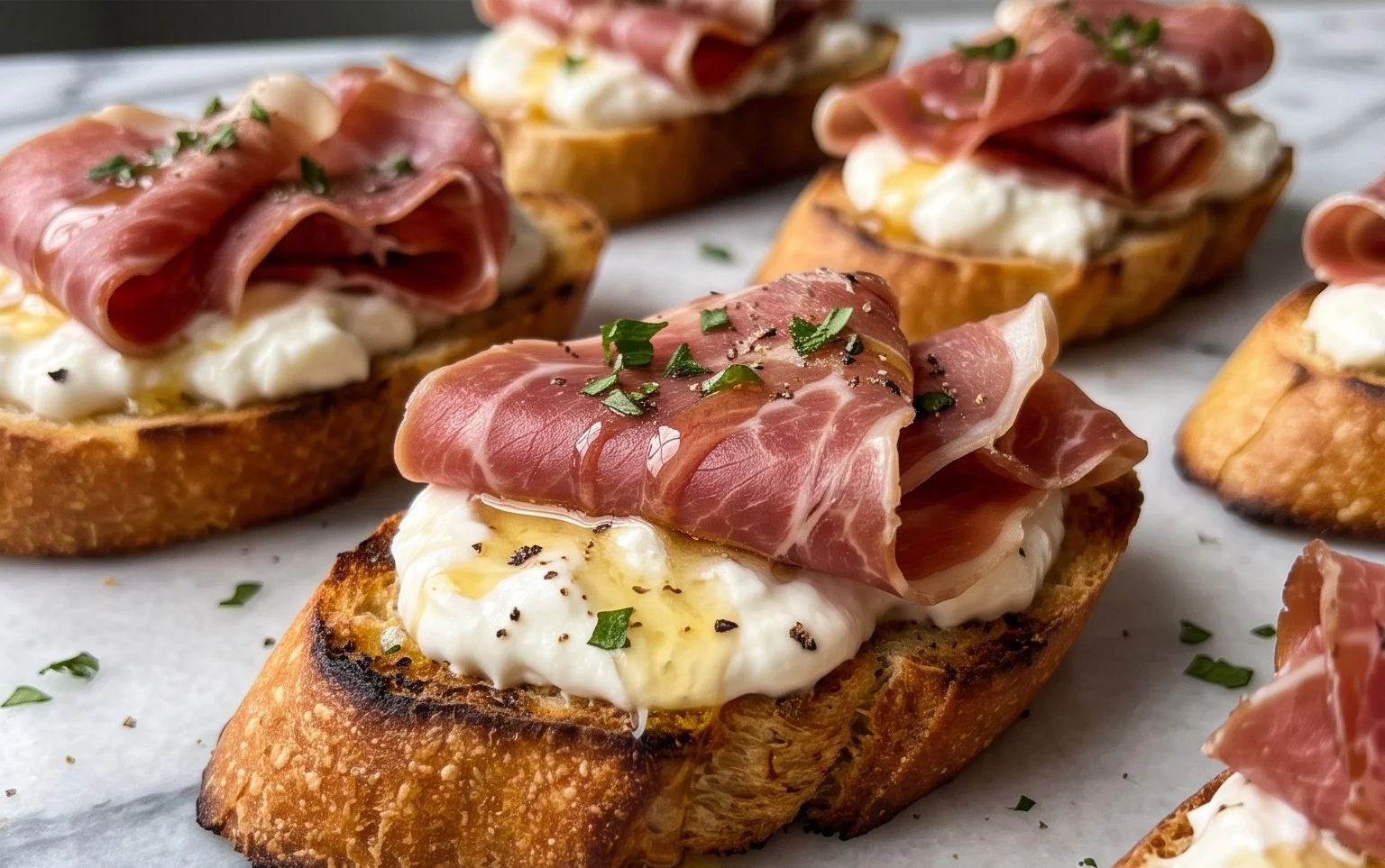 Beef Prosciutto Crostini with Burrata and Lemon Honey Drizzle